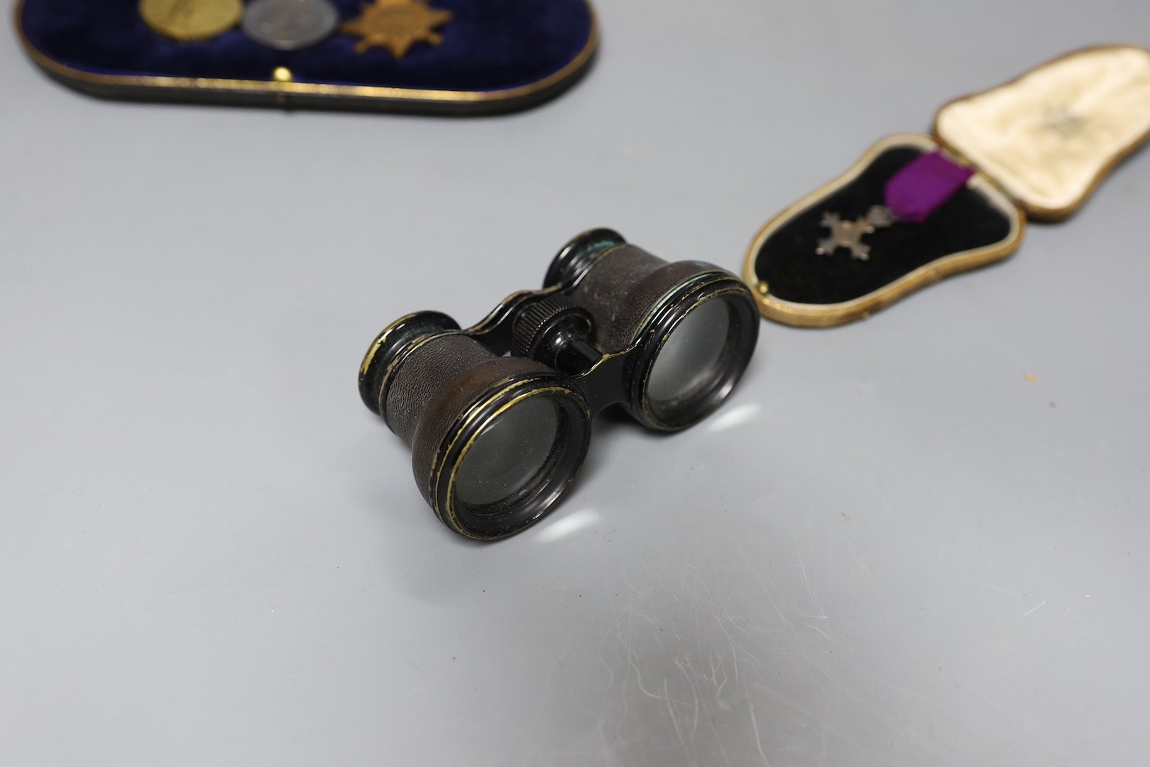 A WWI trio to J L Muir, Royal Fusiliers, a miniature medal, and a pair of opera glasses